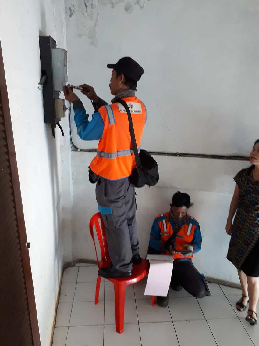 An electricity meter being serviced