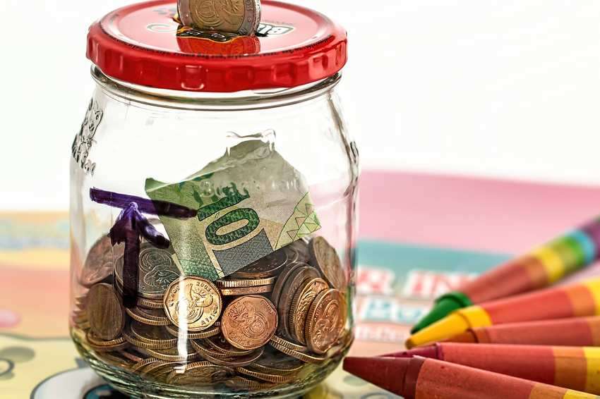A piggy bank surrounded by coins