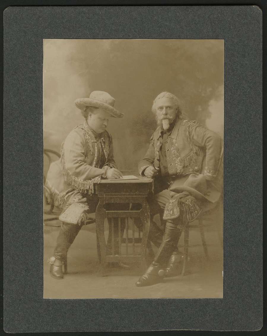 Two men signing a contract, circa 1908