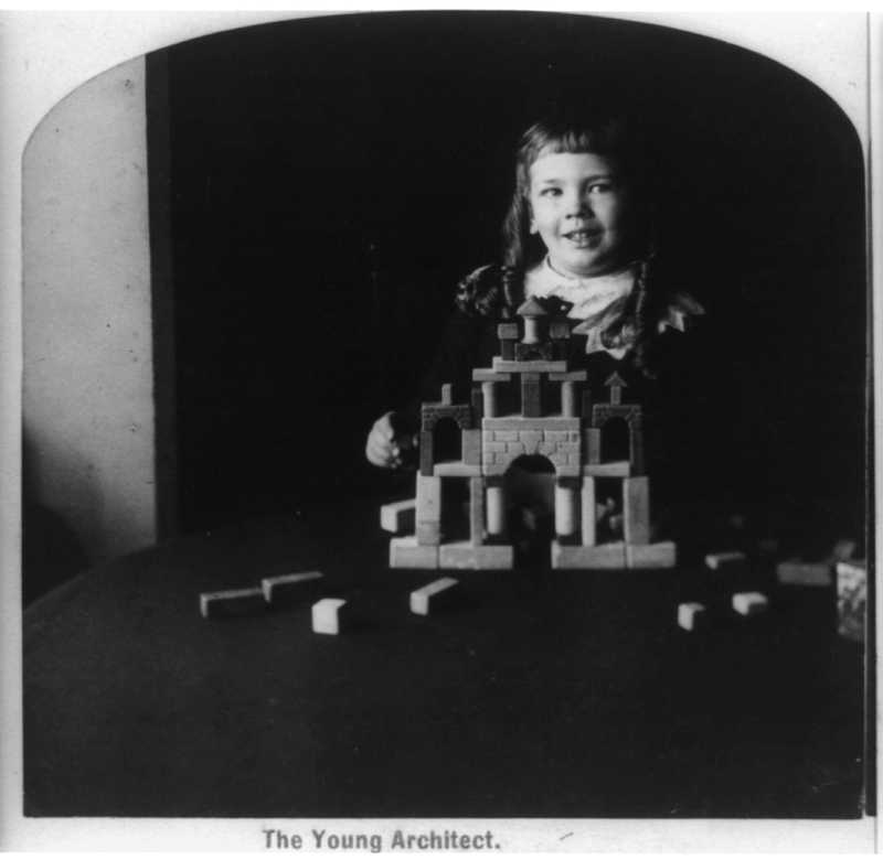 Playing with blocks - nurseries care for children until they turn three